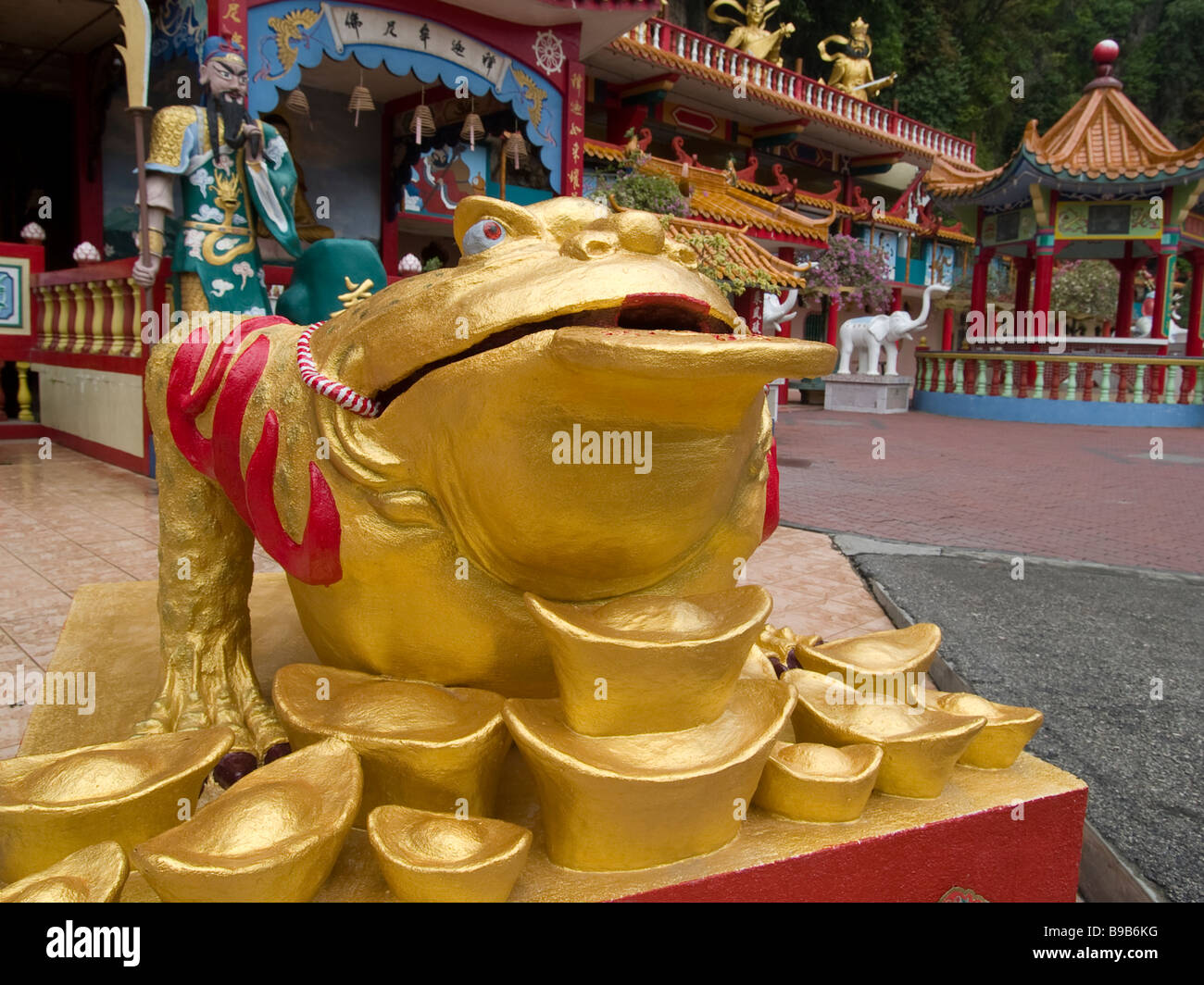 a frog guards his pile of symbolic gold outside a Chinese temple in