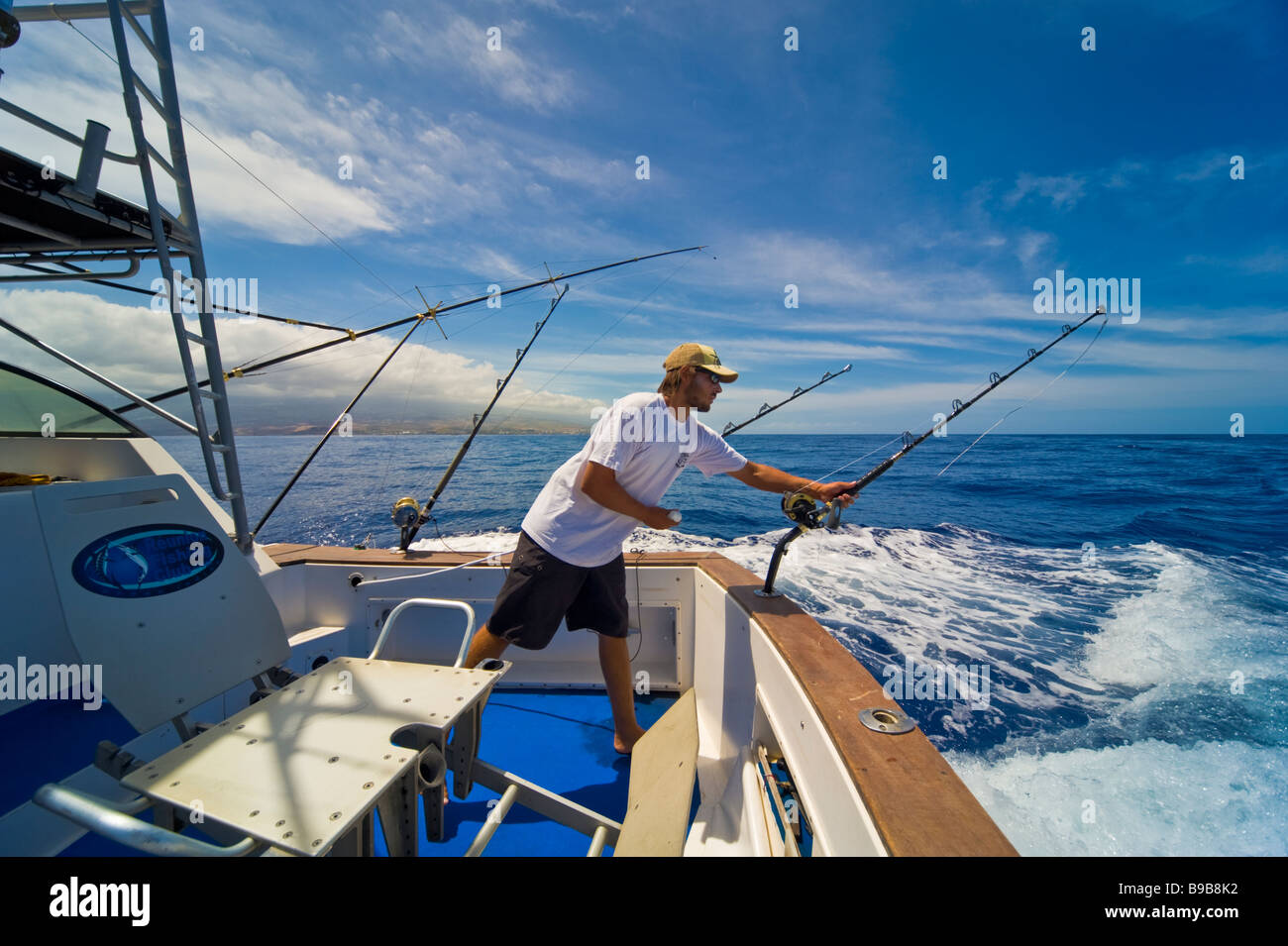 Big game fishing fishermen on fishing boat Saint Gilles La Réunion France | Hochseeangeln, mit Angler und Ruten Stock Photo