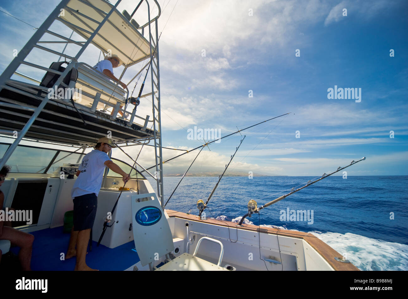 Big game fishing fishermen on fishing boat Saint Gilles La Réunion France | Hochseeangeln, mit Angler und Ruten Stock Photo