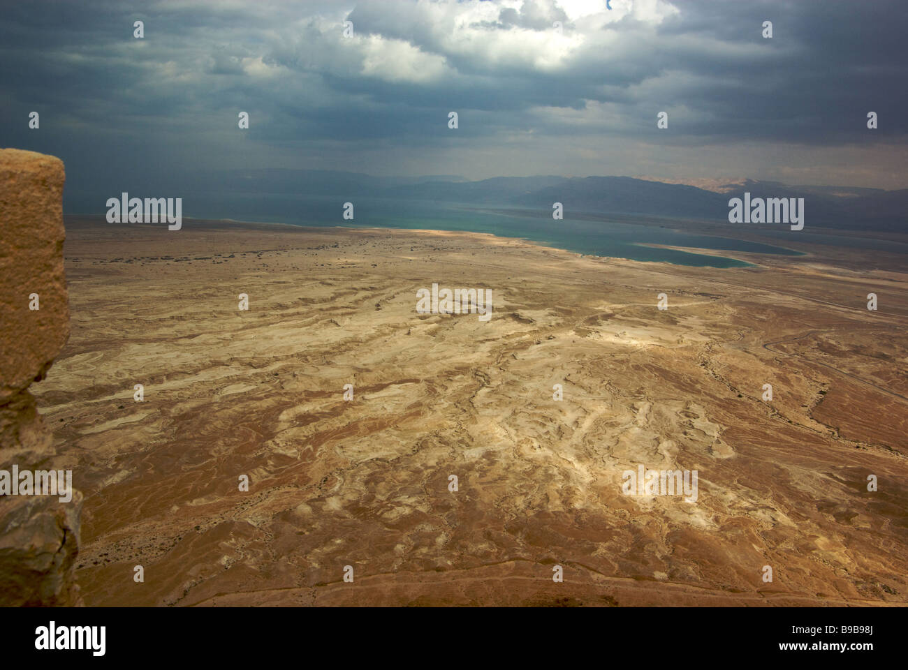 Dramatic view of Judean Desert Dead Sea remnants of several Roman legionary camps beyond the circumvallation wall from Masada Stock Photo