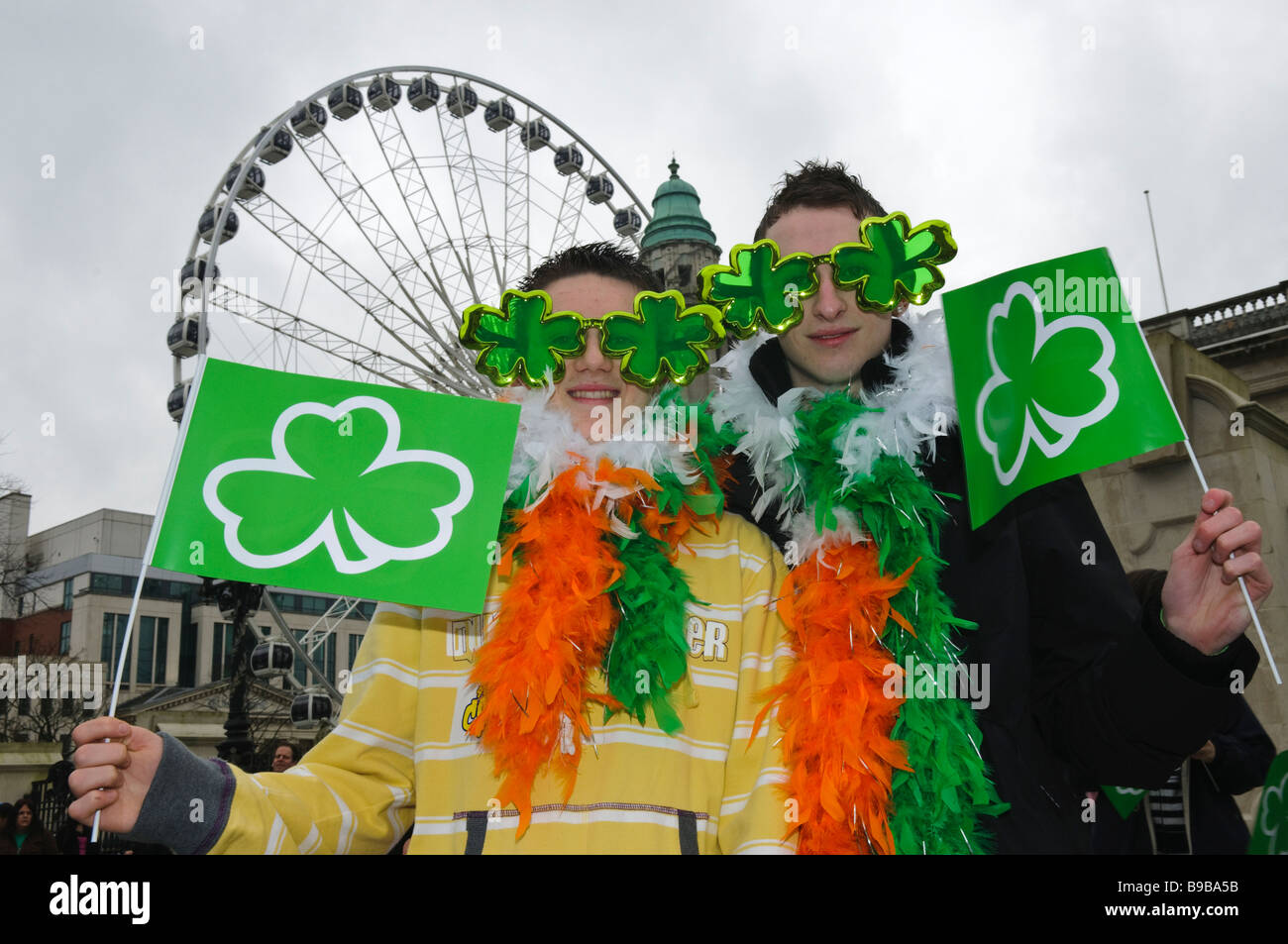 Two teenage boys dressed up for St Patricks Day outside Belfast City Hall and Wheel Stock Photo