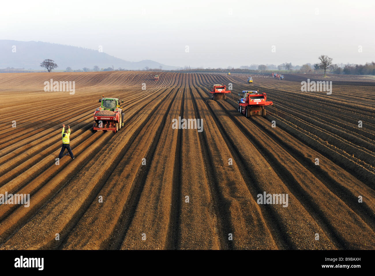 Contract farming tractors and equipment working below The Wrekin hill, Telford, Shropshire Stock Photo