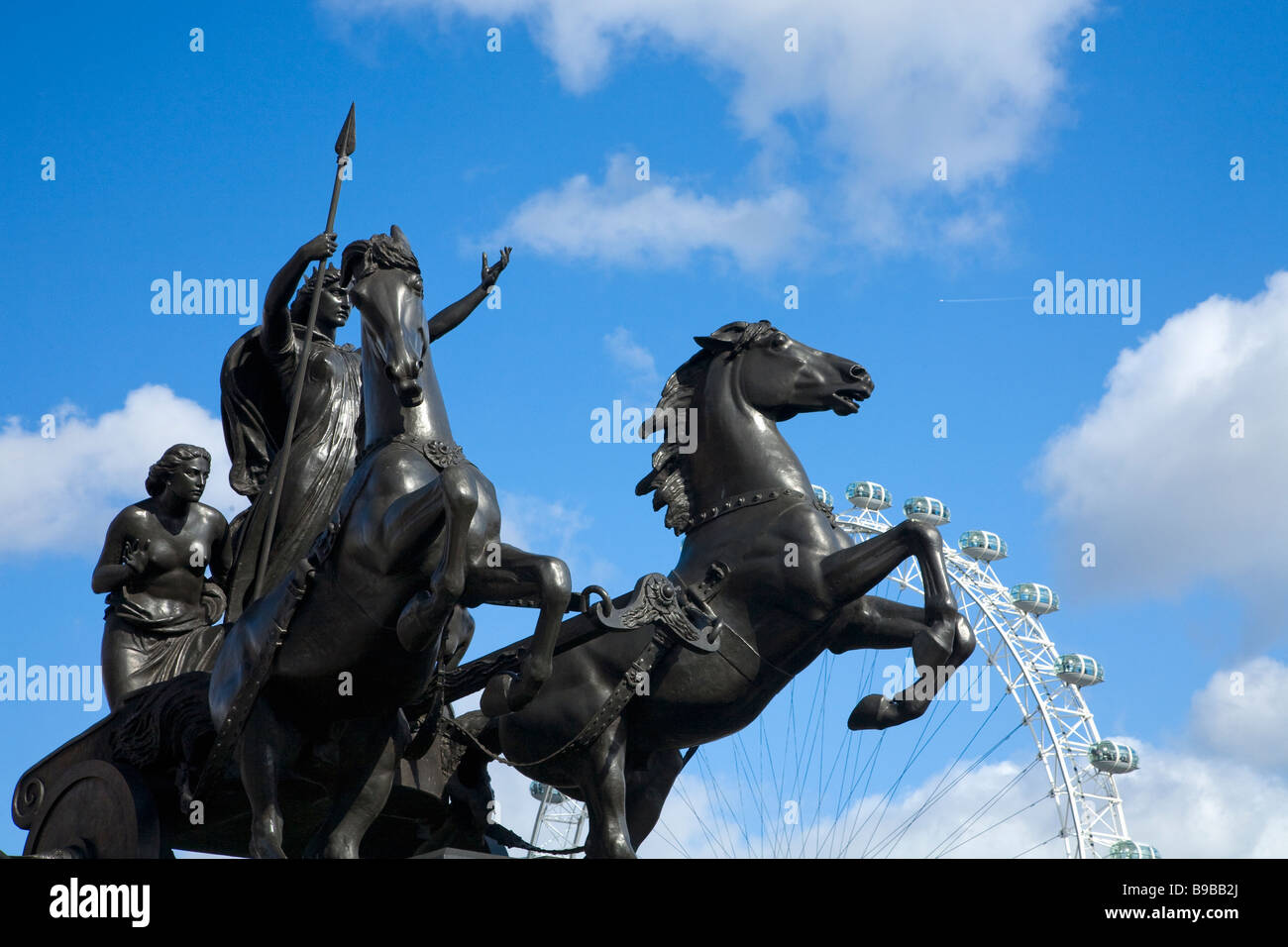 Statue of Boudica Boudicca Boadicea by Thomas Thornycroft and London Eye against blue sky Westminster London England Great Brita Stock Photo