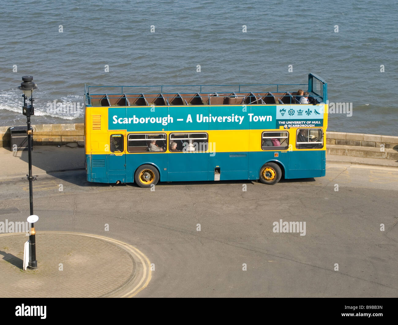 A open topped tourist bus with caption Scarborough A University Town Stock Photo