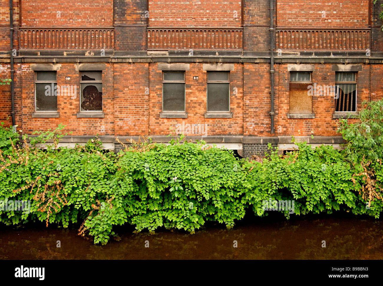 A brick wall of a disused factory in Sheffield Stock Photo