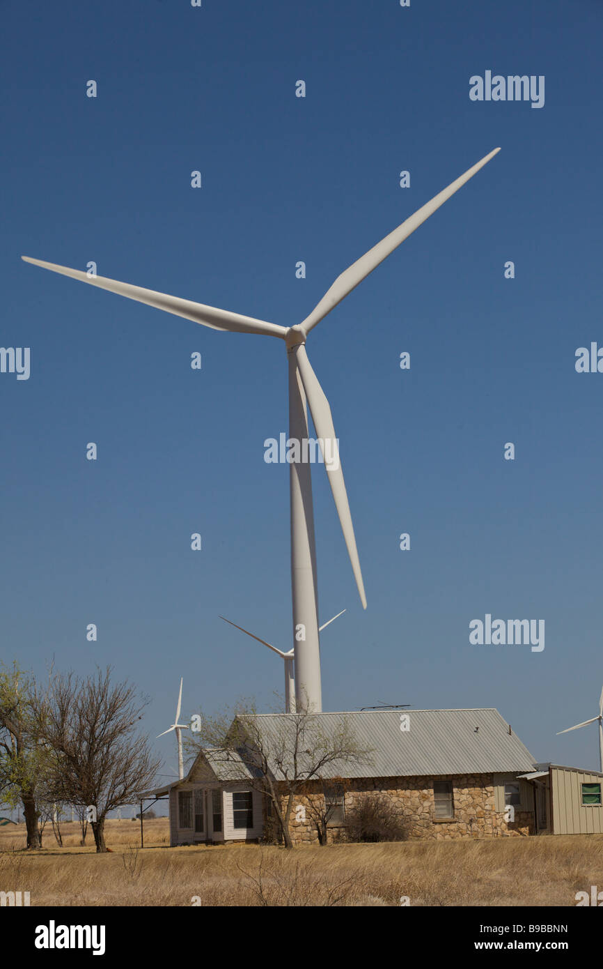 A house next to wind turbines generating electricity at Horse Hollow Wind Farm Nolan county Texas the world's largest Stock Photo