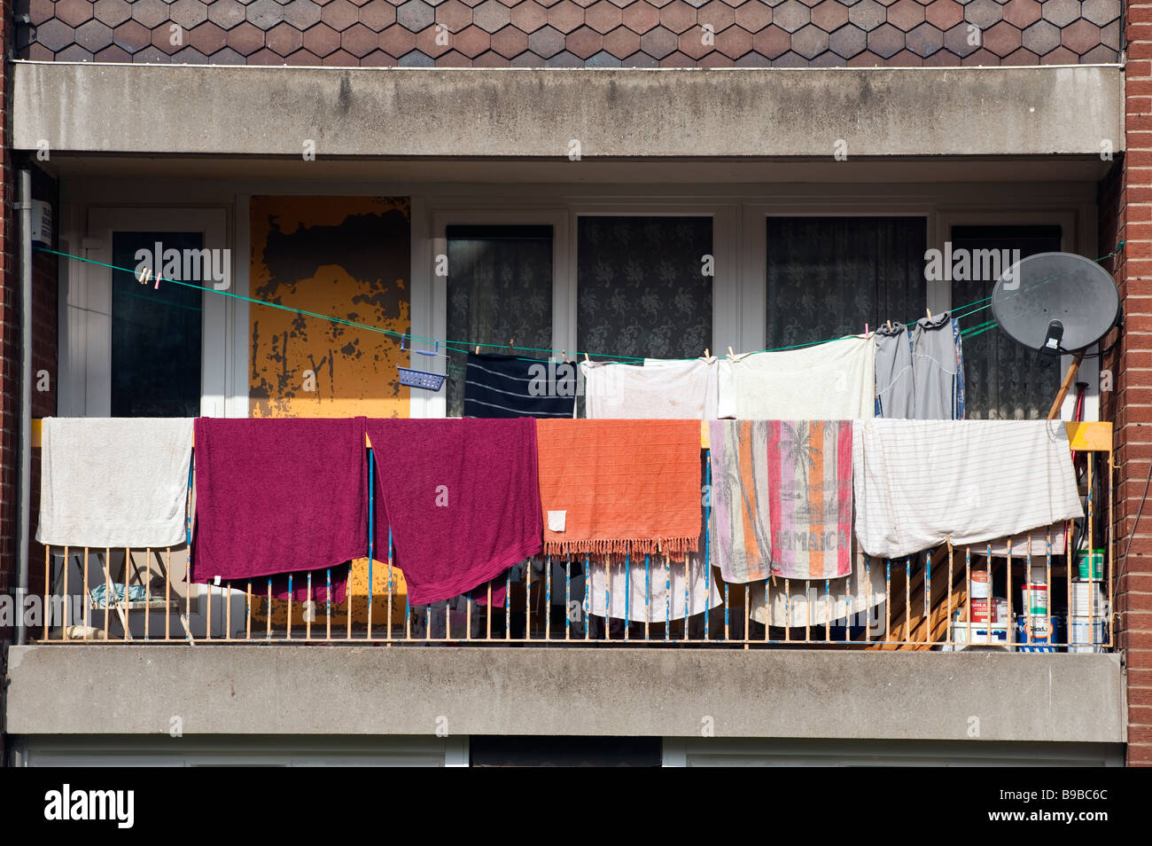 Laundry hung on a balcony in the sun to dry Stock Photo