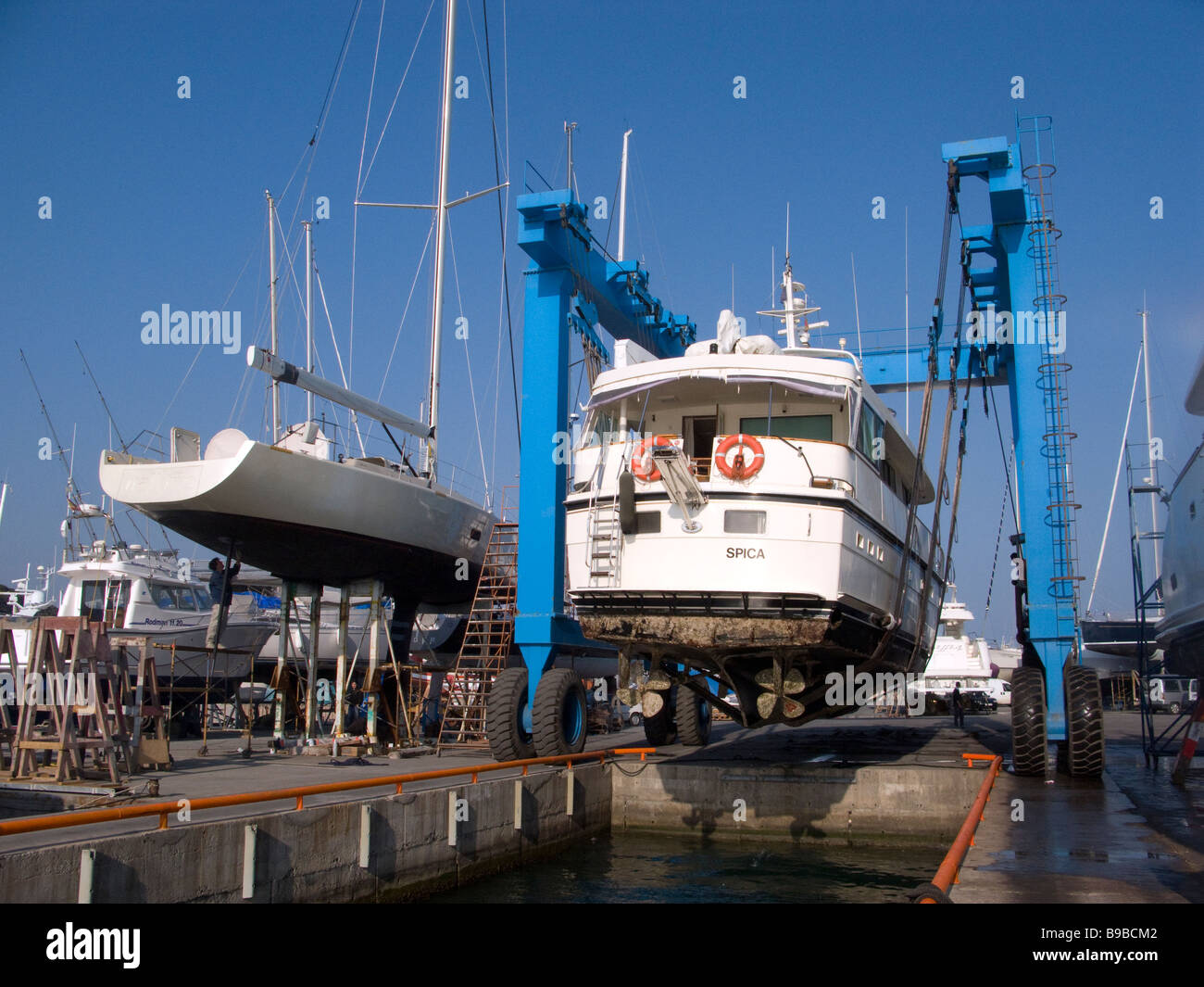 Medium displacement yacht is lifted out of the water for repaint Stock Photo