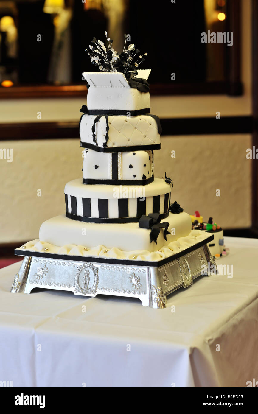 a 5 layer wedding cake on a table at a wedding reception Stock Photo