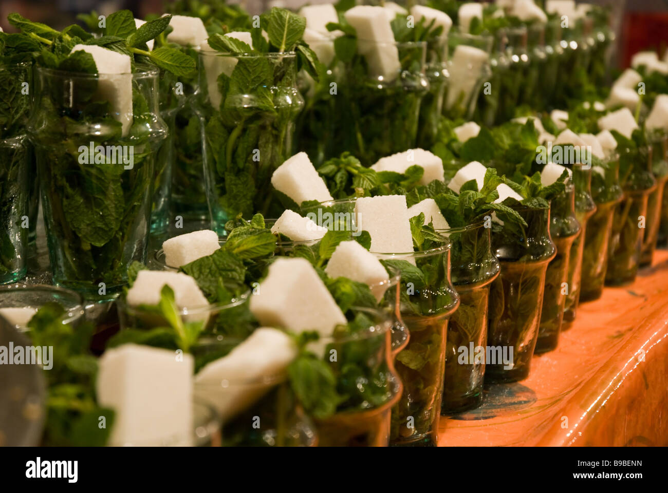 Glasses of mint tea with sugar cubes lined up at a stall in Djemaa El Fna in Marrakech, Morocco. Stock Photo