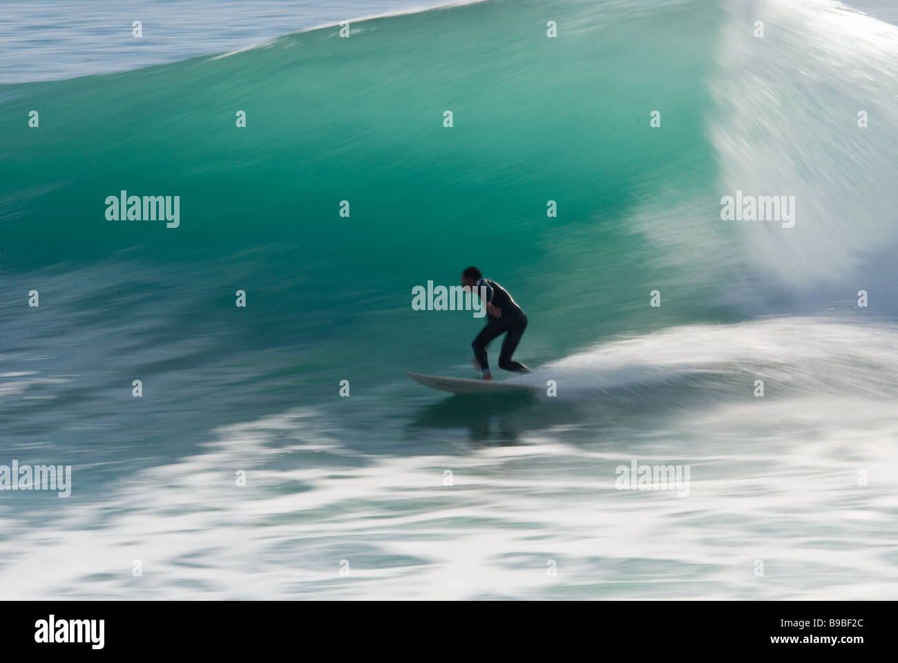 A surfer bottom turns on a wave known as Boilers on Cap Rihr  near Taghazoute, Morocco. Stock Photo