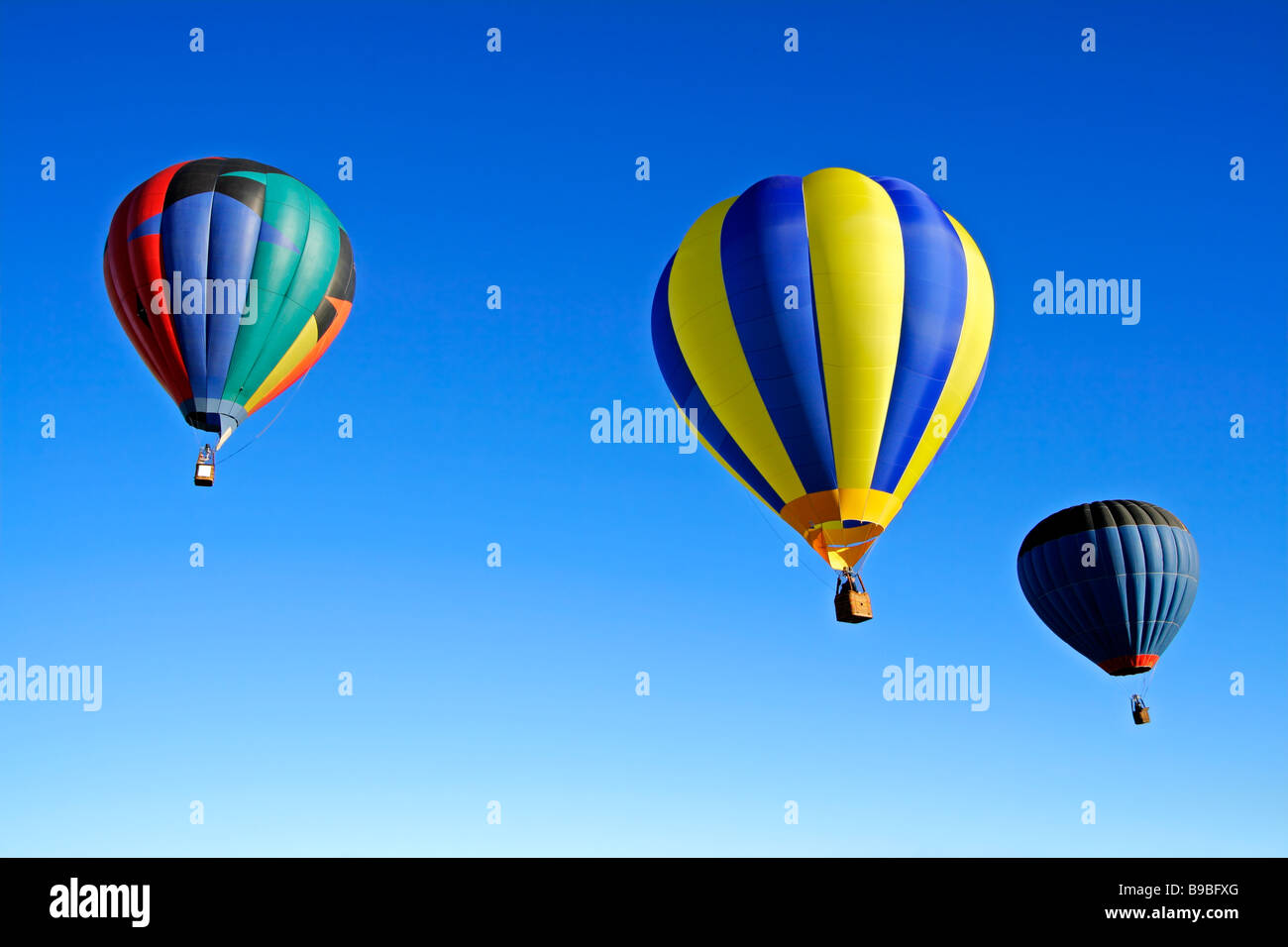 Colorful hot air balloons against a clear blue sky Stock Photo