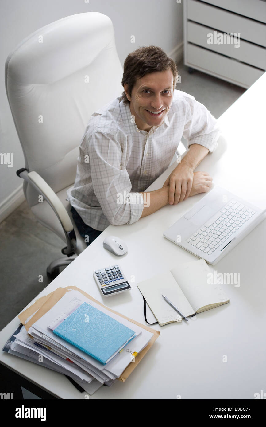 Executive sitting with elbows on desk hi-res stock photography and ...