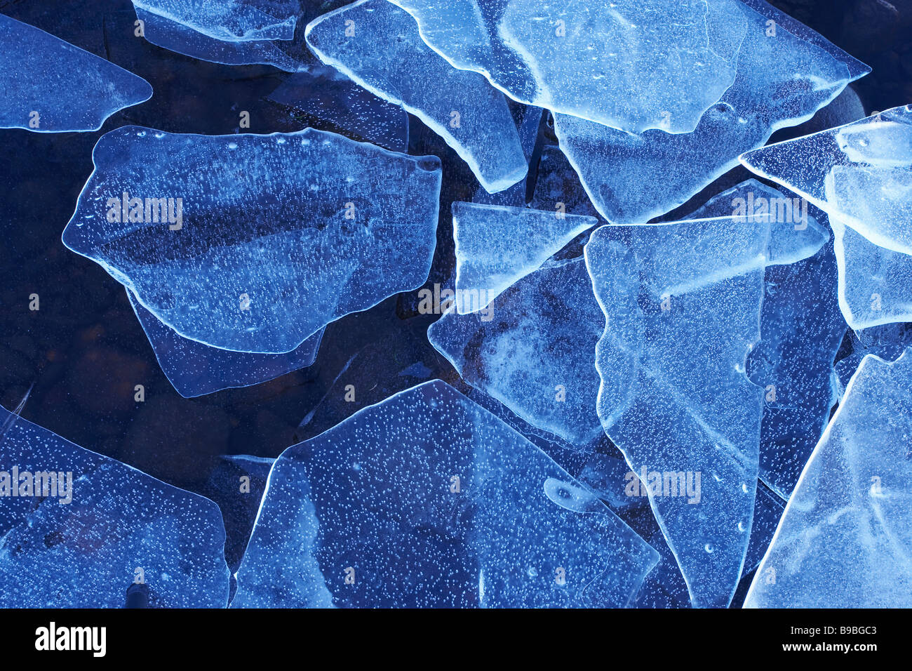 Ice shards on edge of frozen loch Stock Photo