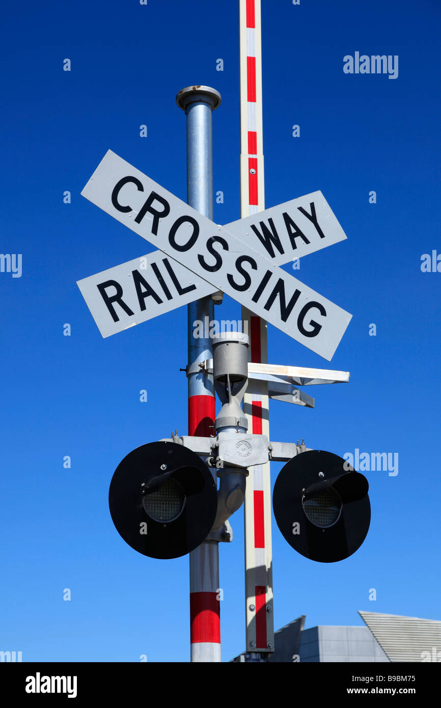 Railway Crossing road sign with lights and barrier,Ashburton,Mid Canterbury,South Island,New Zealand Stock Photo