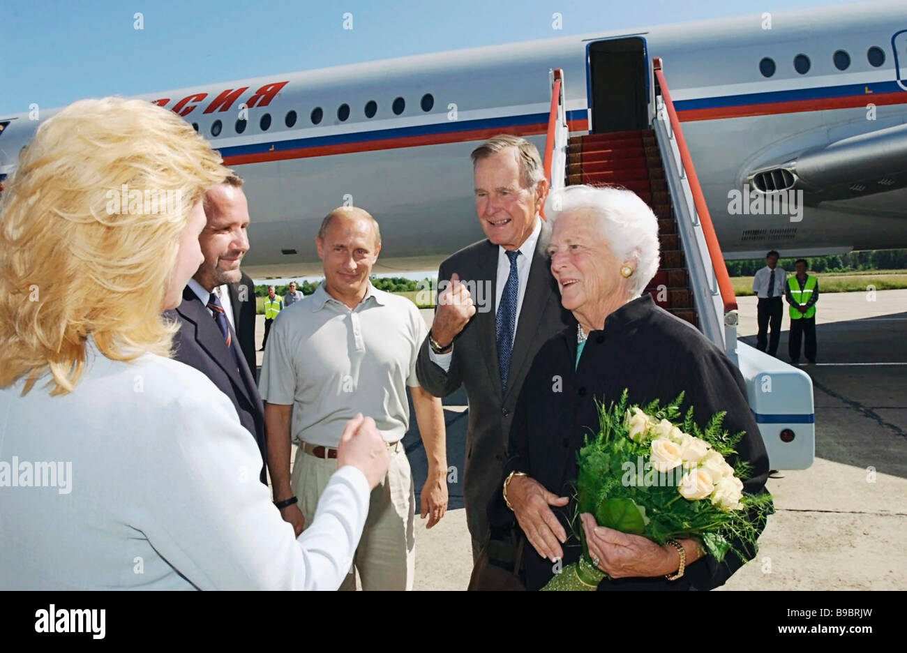 Russian President Vladimir Putin welcomes former US President George Bush Sr and Mrs Barbara Bush who have arrived on a private Stock Photo