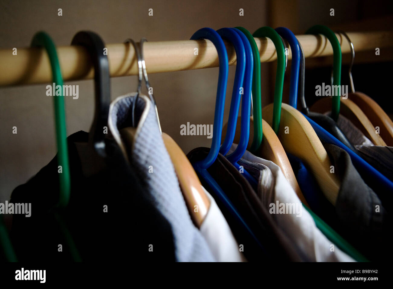 Clothes hanging in a cupboard Stock Photo Alamy