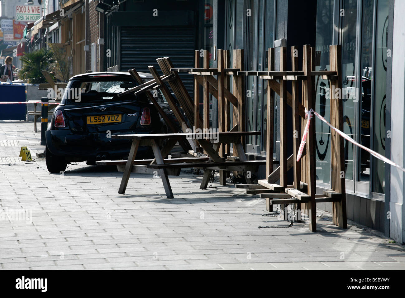 A road traffic accident leaves a car on the pavement on Clapham High Street, south London. Stock Photo