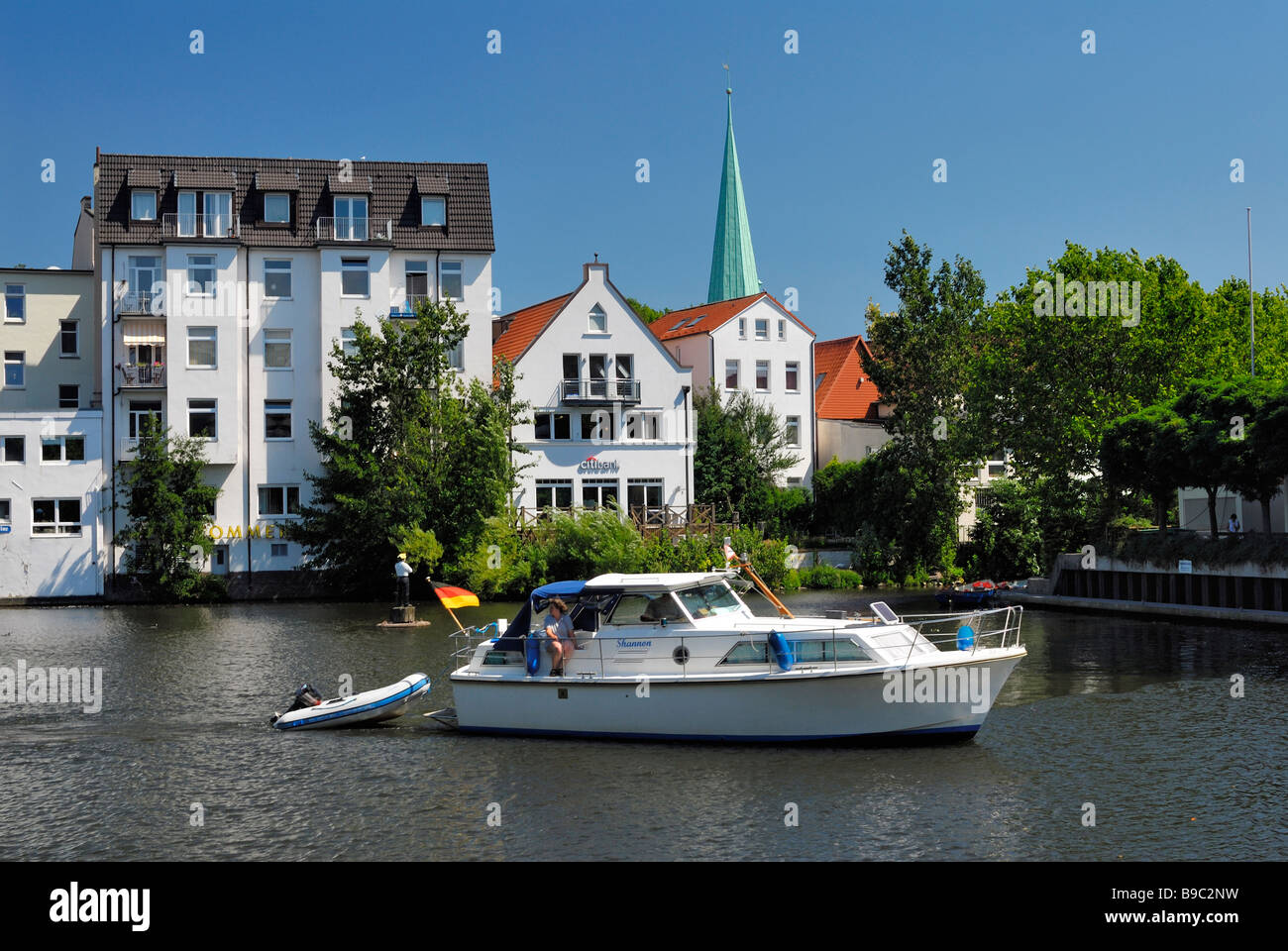 Sport boat upon the Serrahn and steeples of St. Petri and Pauli church in Bergedorf, Hamburg. Stock Photo