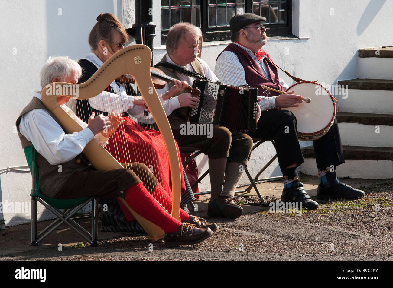 Welsh musicians in traditional period dress performing at Llanover Hall, Abergavenny, Wales, UK. Stock Photo
