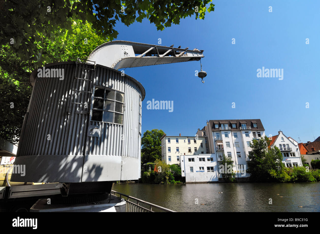 Historic crane at the waterside of the Serrahn in Bergedorf, Hamburg. Stock Photo