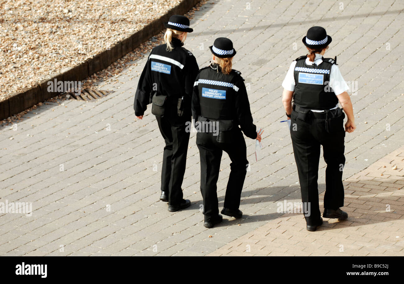 Three Police Community Support Officers PCSO s walking along Brighton seafront UK Stock Photo