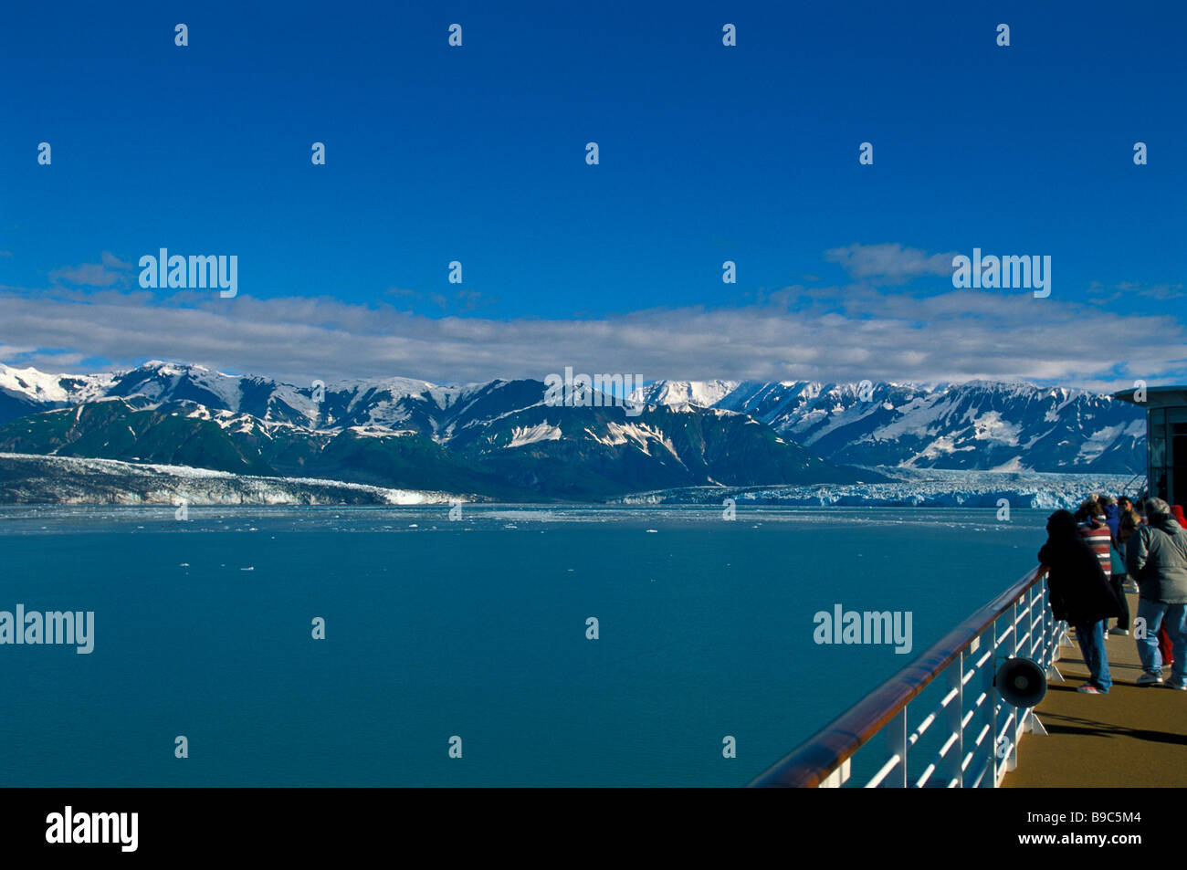 Alaska cruise ship entering Glacier Bay passengers on deck railing view glaciers blue ice Stock Photo