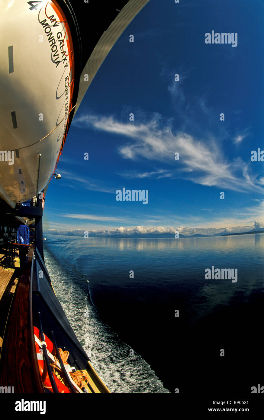 Alaska Cruise ship Inside Passage sunny weather fisheye view cruise ship water snow capped mountains life boat Stock Photo