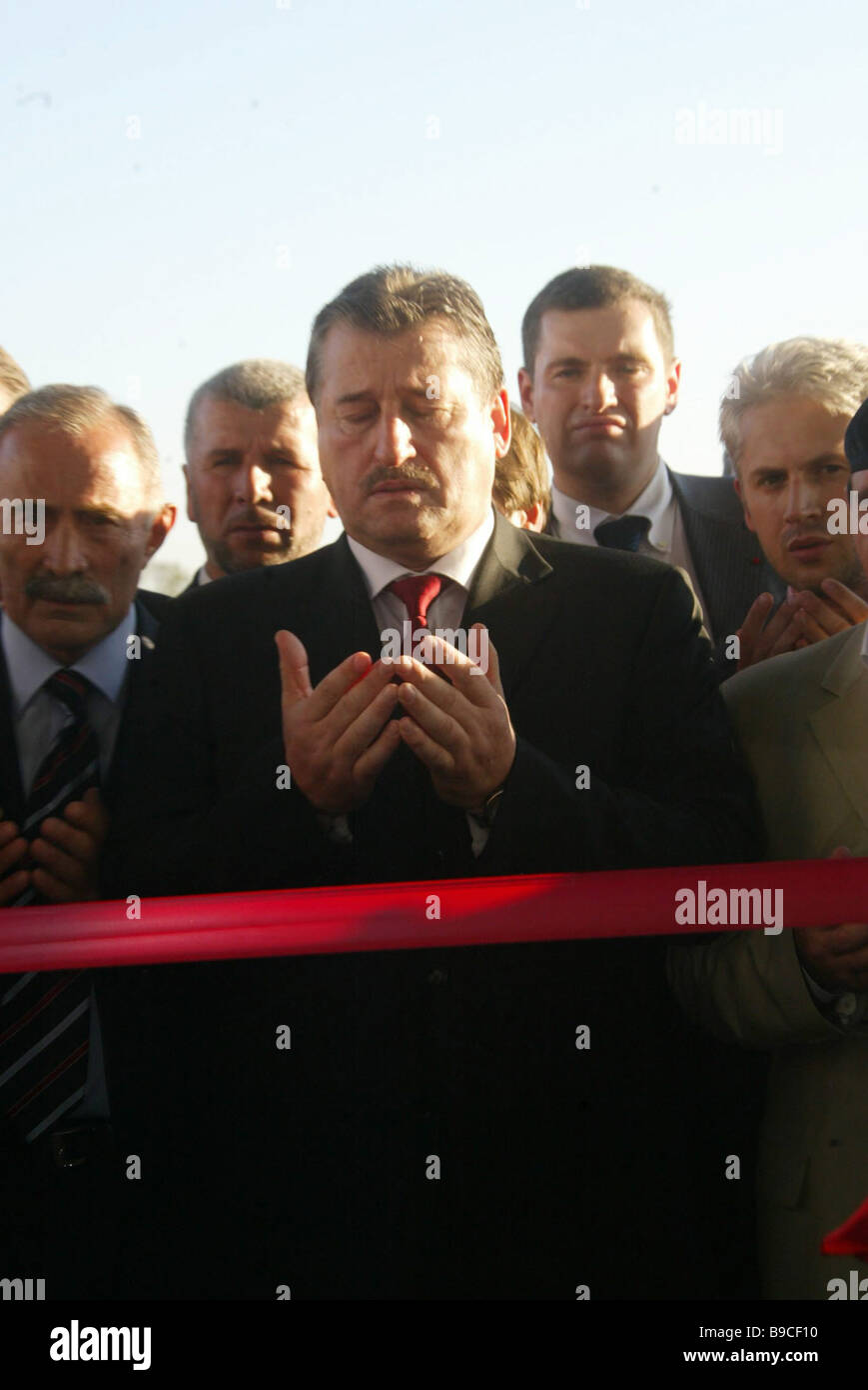 Chechen President Alu Alkhanov praying before the opening of the Grozny