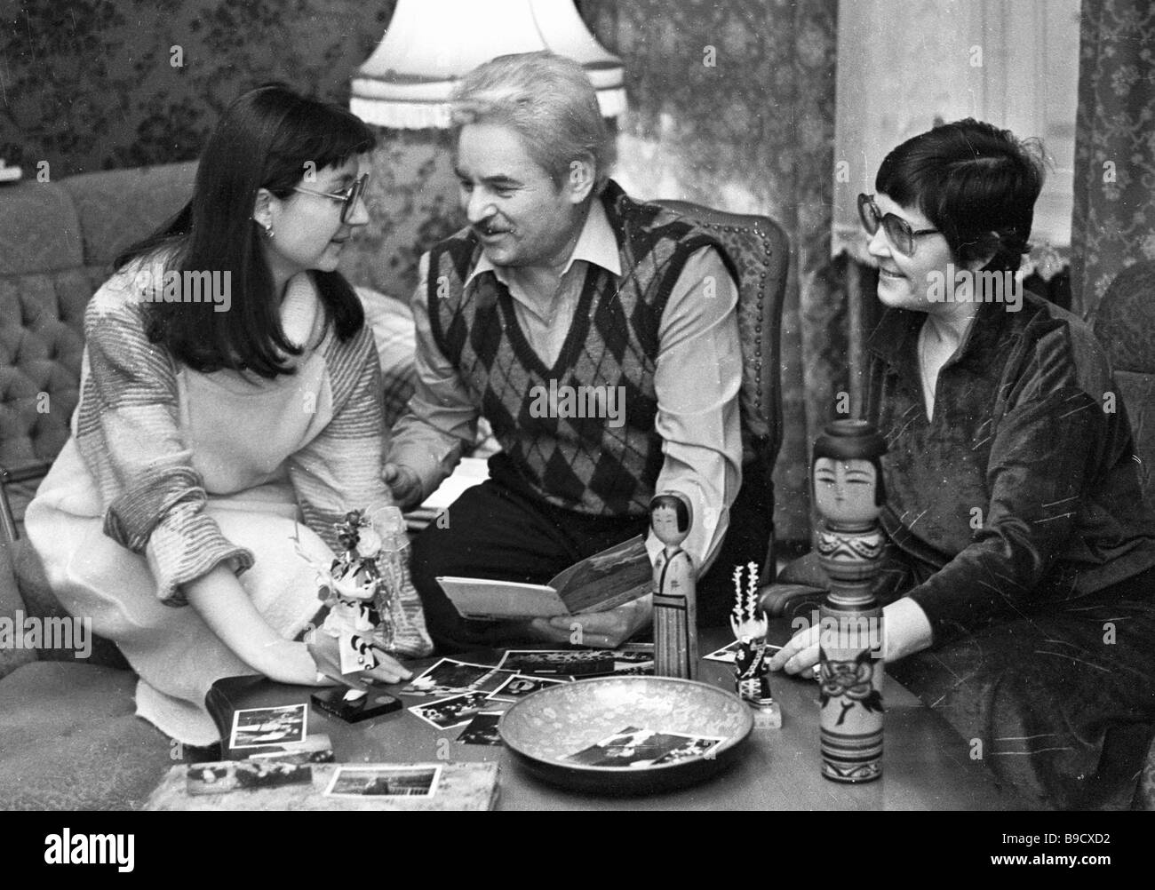 Writer Anatoly Ananyev center showing souvenirs from Japan to his