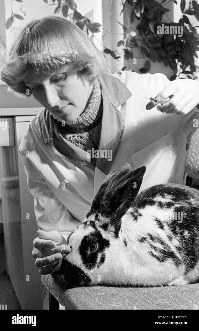 A research fellow conducting experiments on a laboratory rabbit named Toobley Experimental
