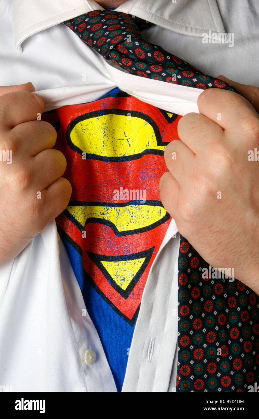 Businessman revealing a superman logo Stock Photo