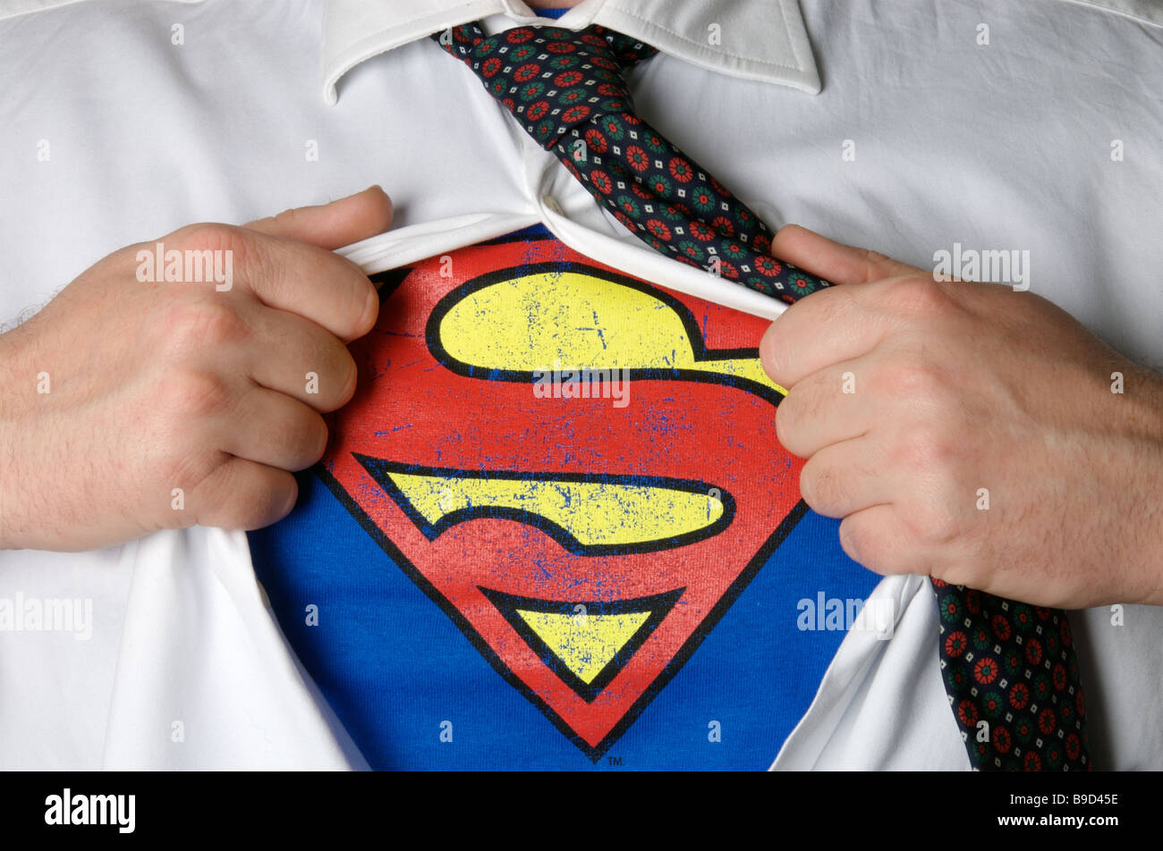 Businessman revealing a superman logo Stock Photo