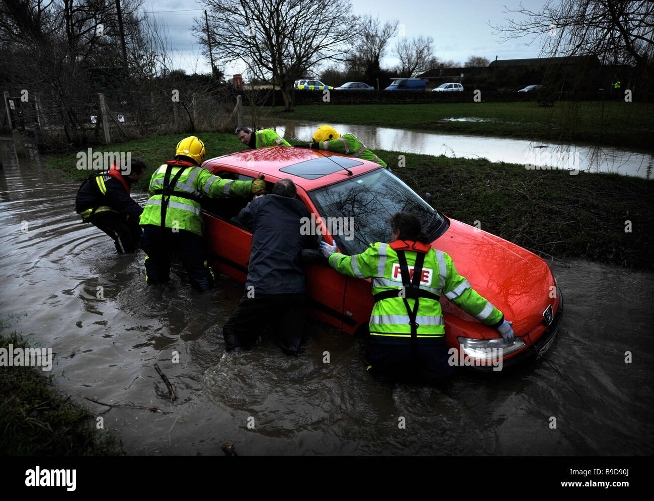 FIREMAN RESCUE A FEMALE MOTORIST CAUGHT BY FLOODWATER IN THE VILLAGE OF CRUDWELL NEAR MALMESBURY GLOUCESTERSHIRE UK JAN 2008 Stock Photo