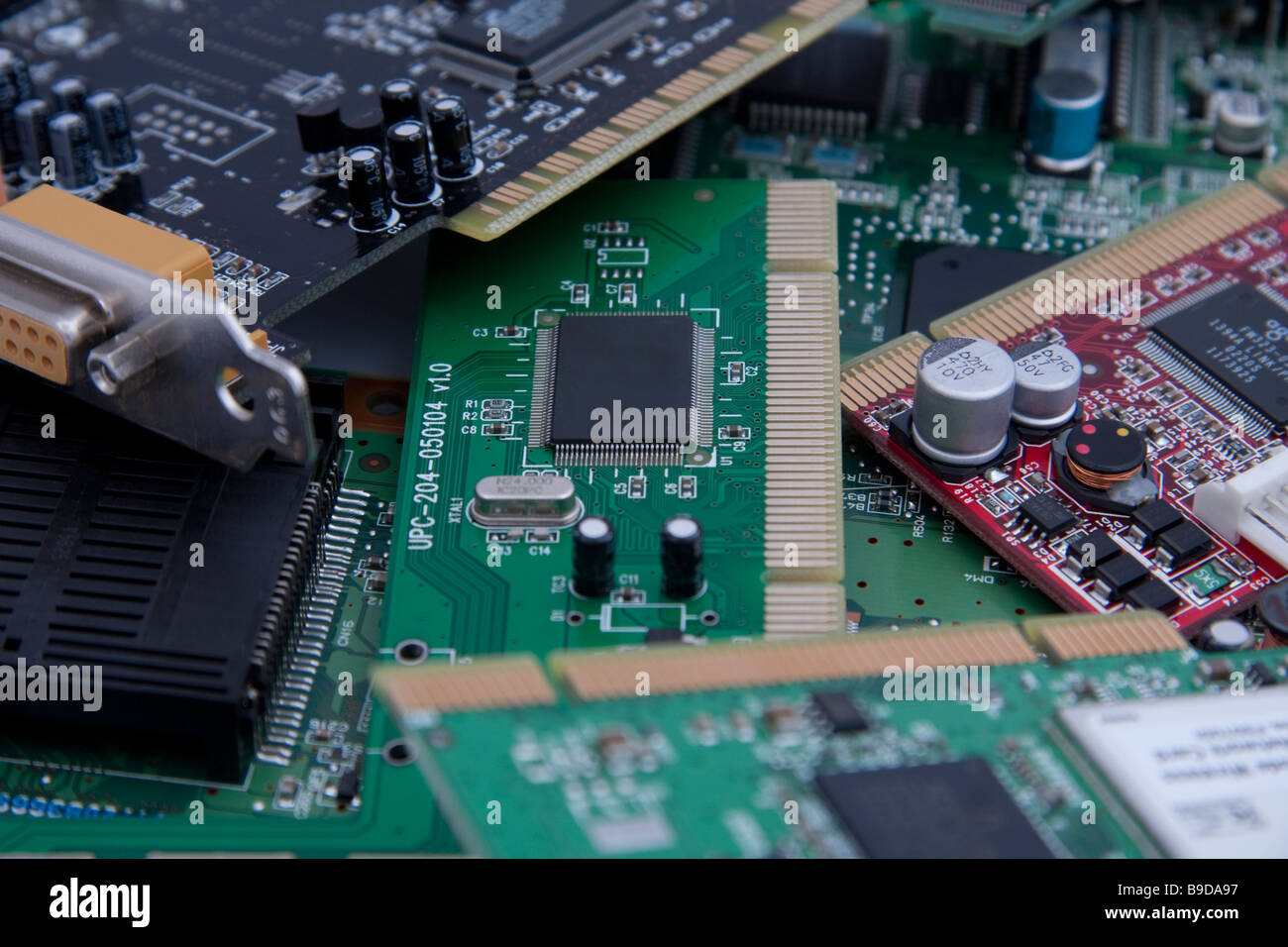 Group of circuit boards sockets screws chips green red resistors Stock