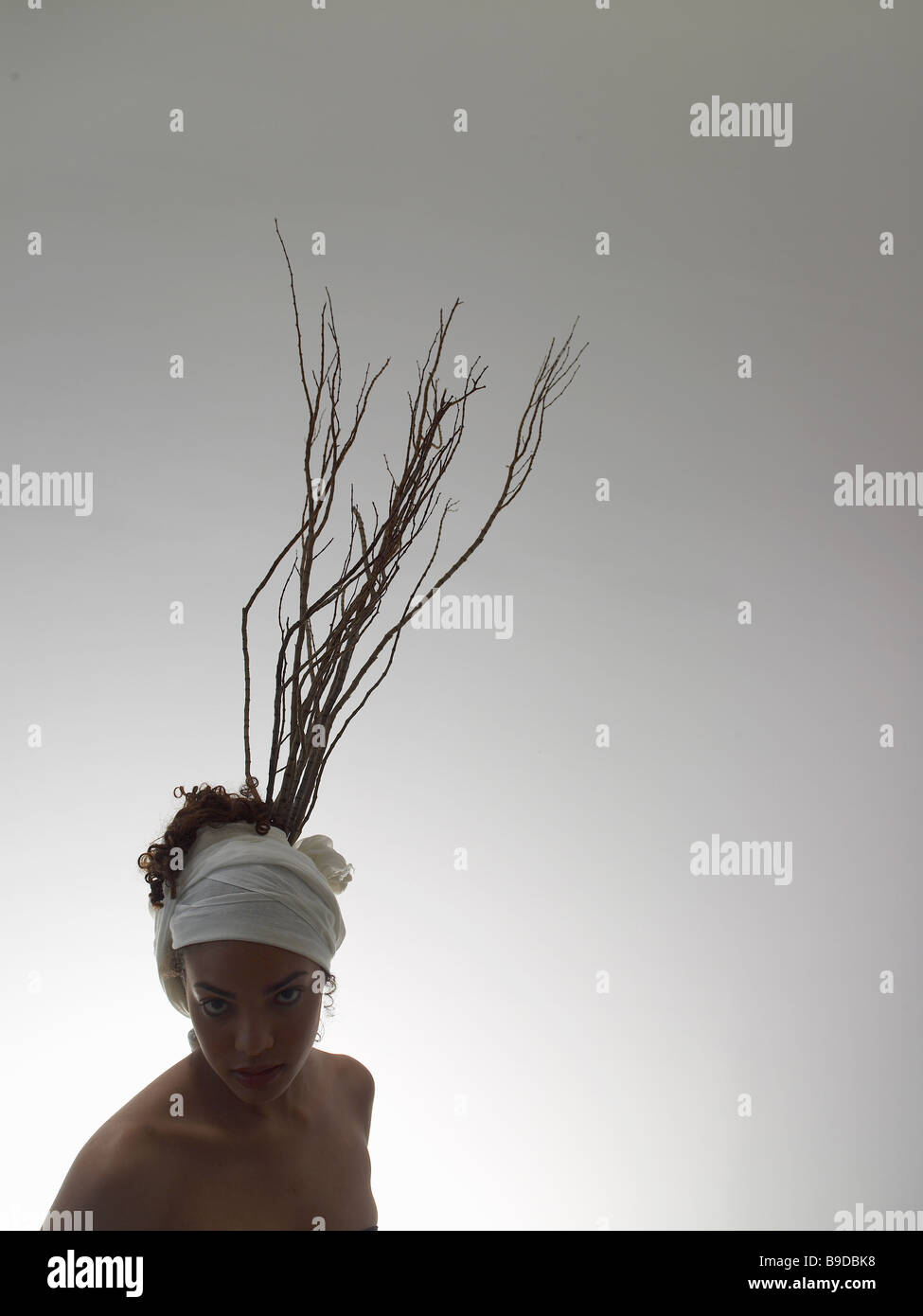 Women with tree branches attached to head for decoration Stock Photo