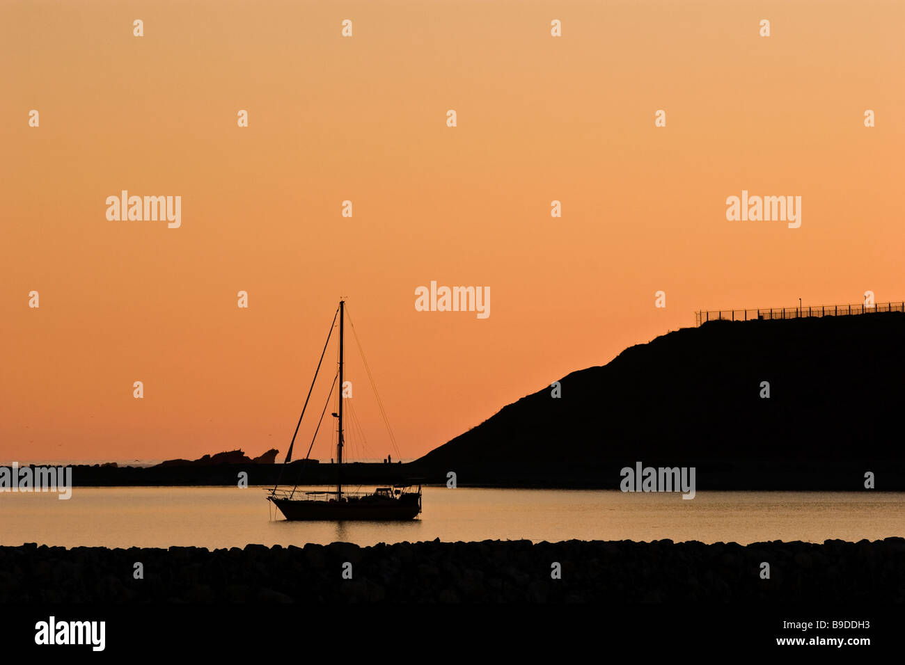 Sailboat at sunset, Pillar Point Harbor, California Stock Photo
