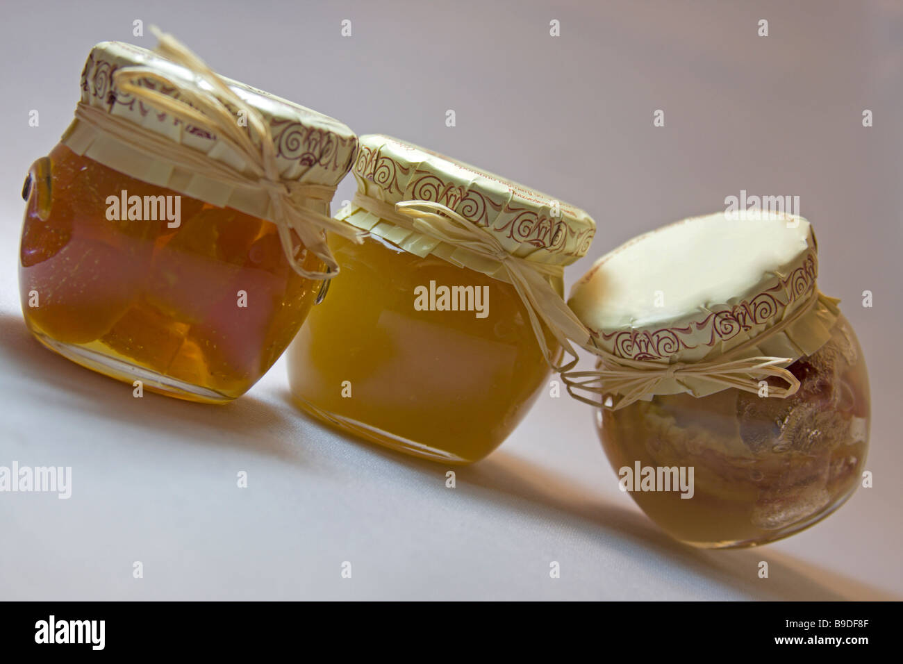 Honey and marmalade in the small jars. Home made food from the grandma