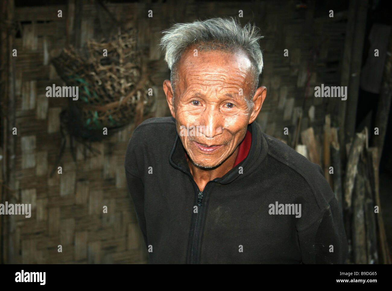 Smiling Elder Ao Naga Tribe Man Standing Outside His Home Stock Photo