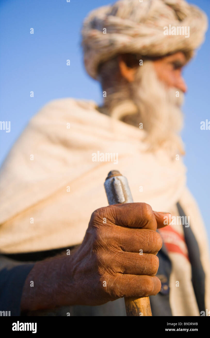 Man holding a walking stick, Pushkar, Ajmer, Rajasthan, India Stock Photo