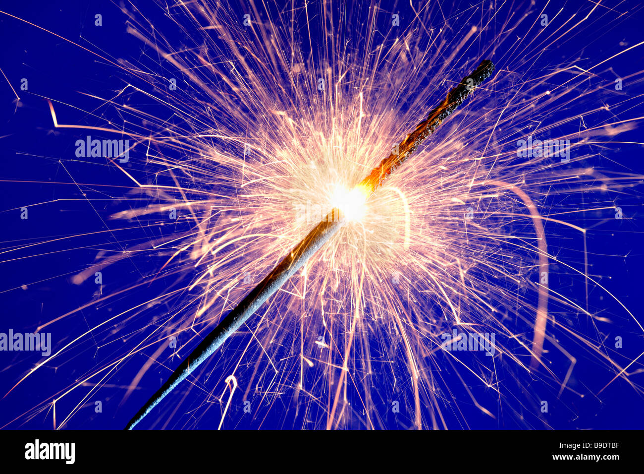 sparkler against blue background Stock Photo