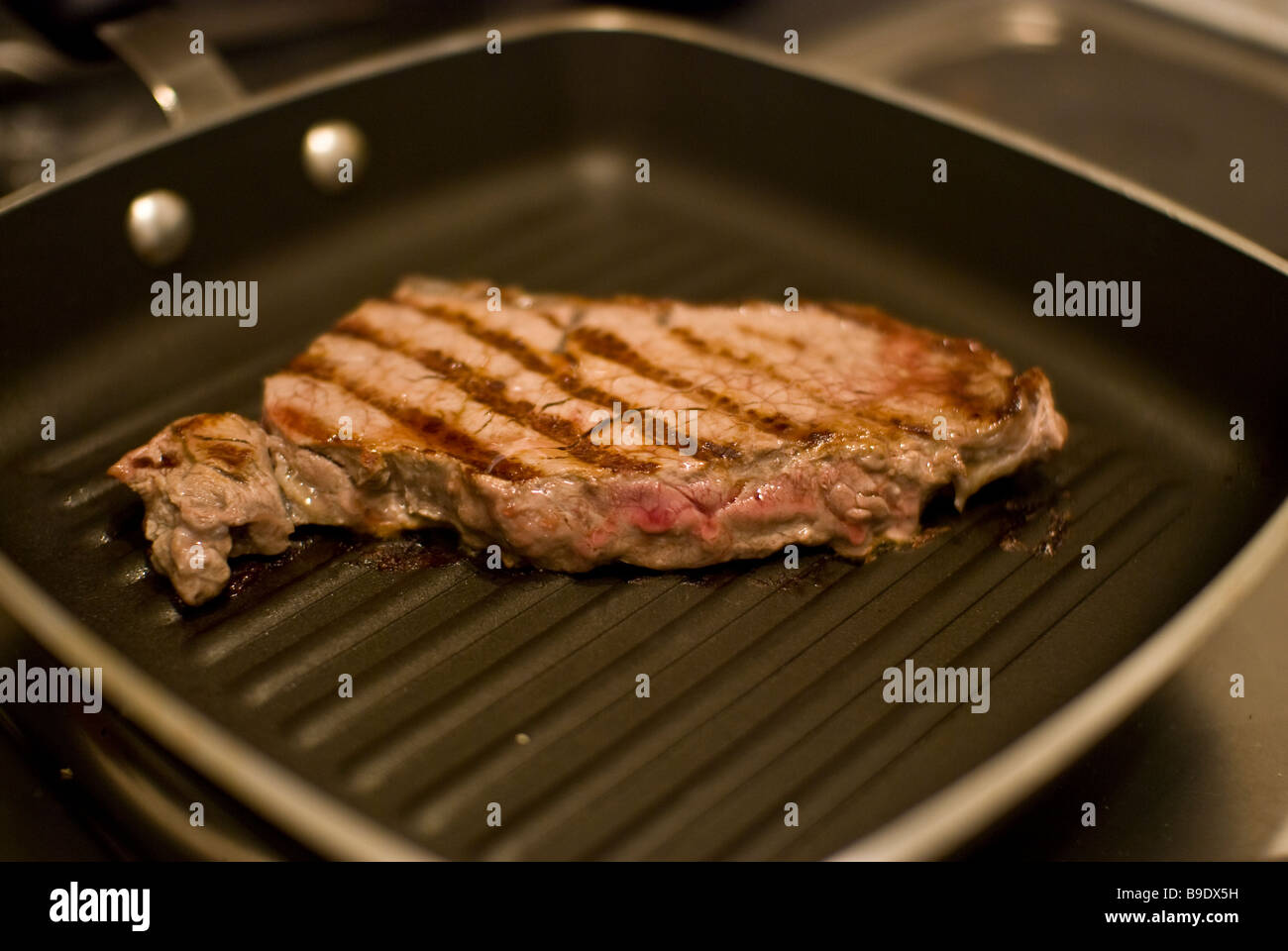 A Sirloin Steak Frying In A Griddle Pan Stock Photo Alamy a-sirloin-steak-frying-in-a-griddle-pan-stock-photo-alamy