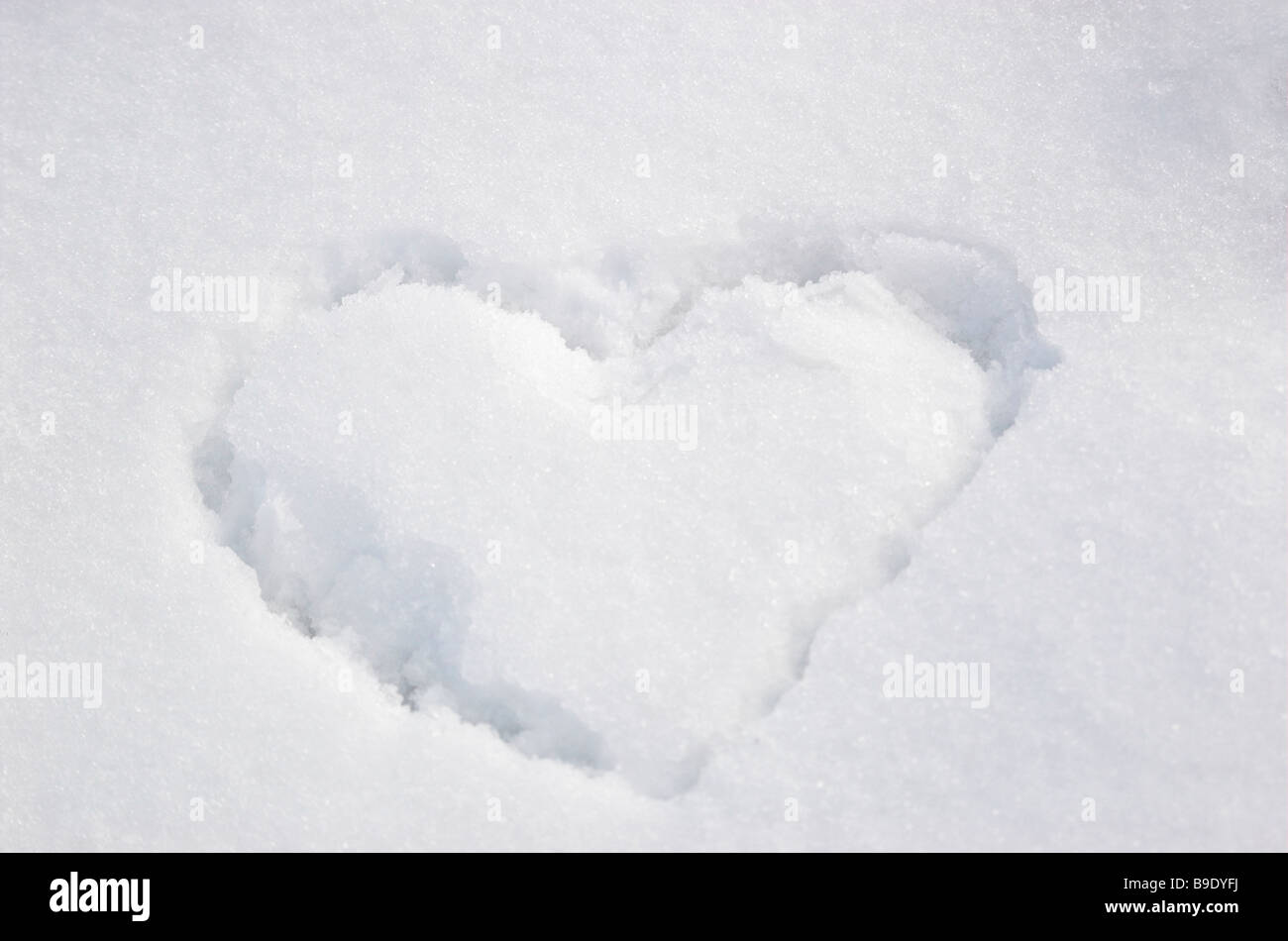 Heart shape in snow Stock Photo