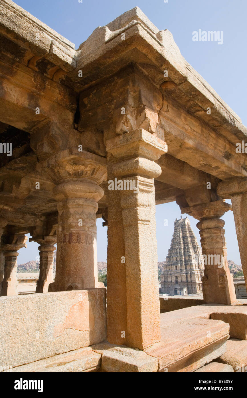 Ornate columns with a temple in the background, Virupaksha Temple, Hampi,  Karnataka, India Stock Photo - Alamy