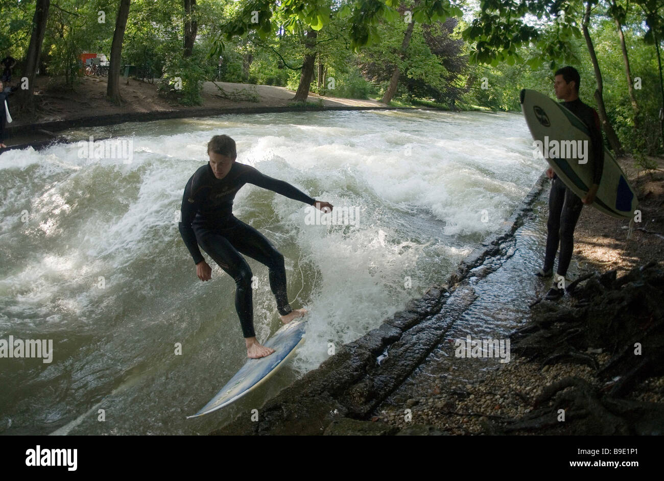 Surfer practising on the Eisbach river, Munich, Germany Stock Photo