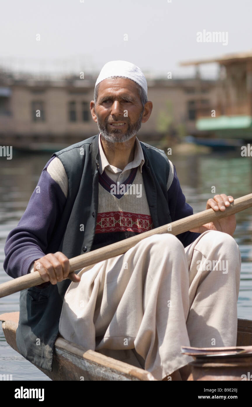 Man rowing a boat, Dal Lake, Srinagar, Jammu And Kashmir, India Stock Photo