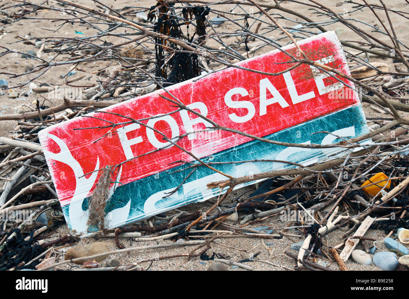 A  faded 'For Sale' sign washed up on a UK beach Stock Photo