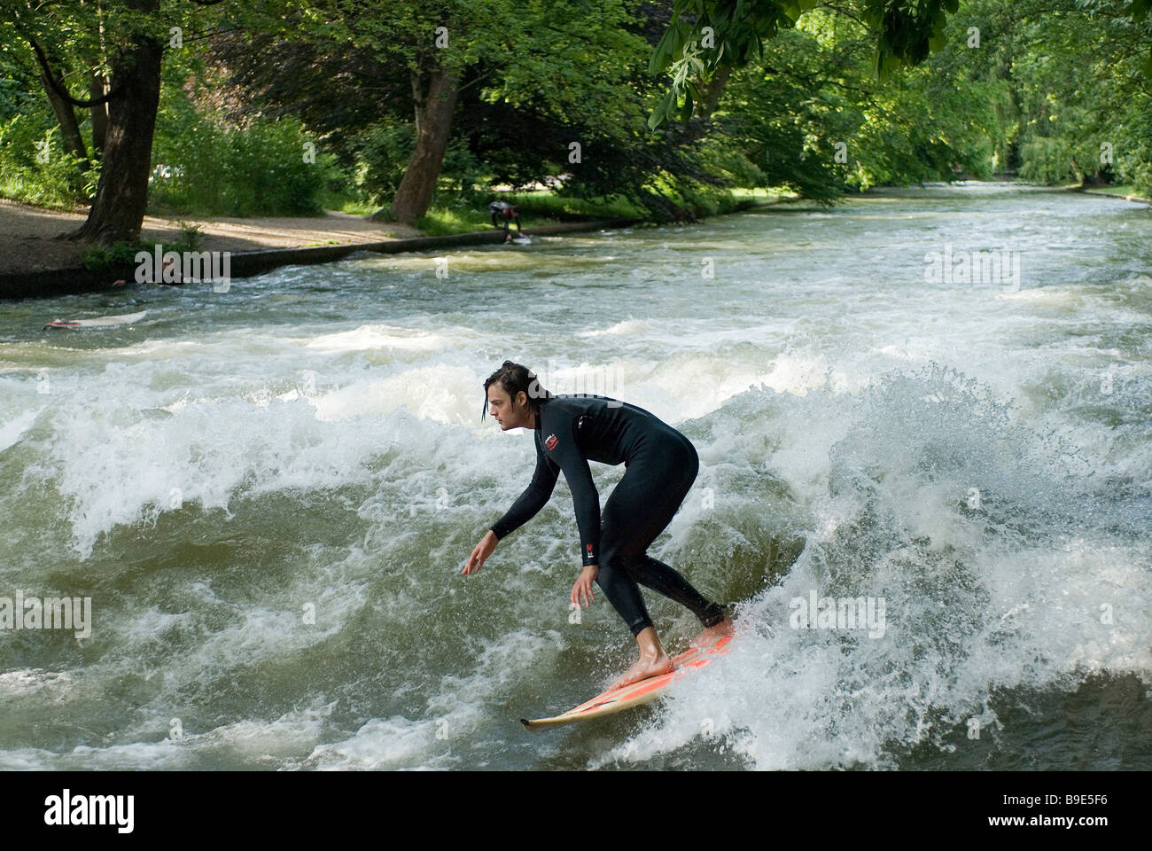 Surfer practising on the Eisbach river, Munich, Germany Stock Photo