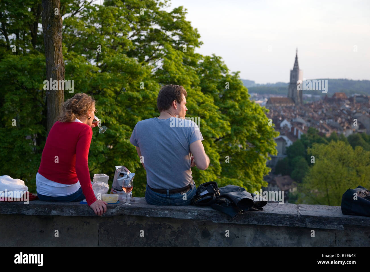 Couple sitting on a wall while enjoying a picnic Rosengarten Berne Canton of Berne Switzerland Stock Photo