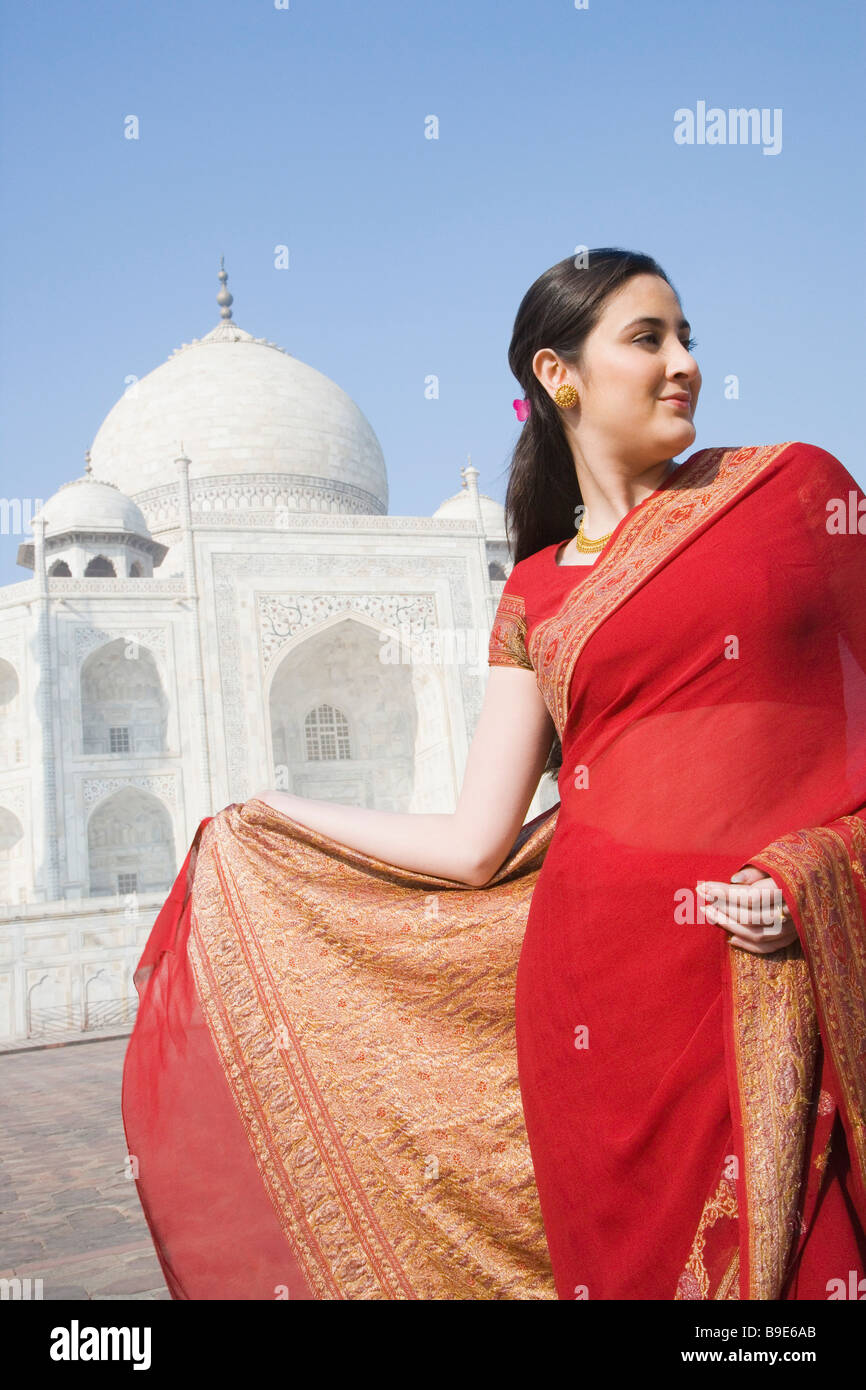 Woman standing in front of a mausoleum, Taj Mahal, Agra, Uttar Pradesh ...